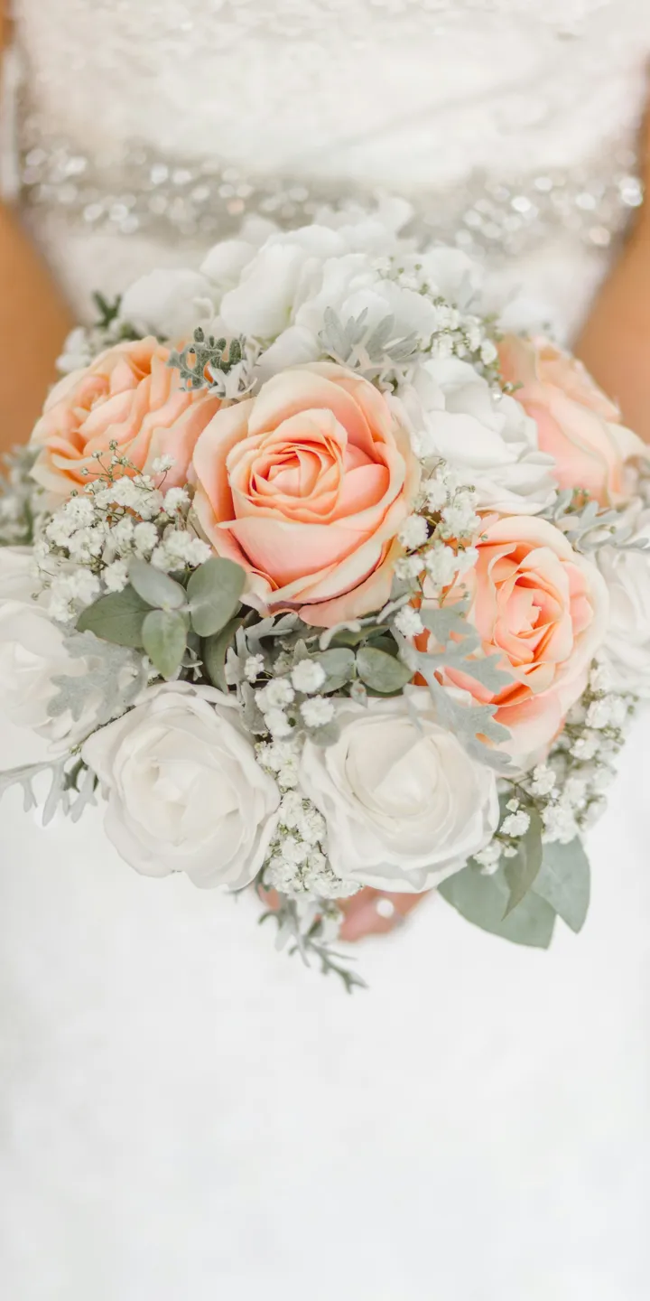 Bride holding a bouquet with pink and white roses