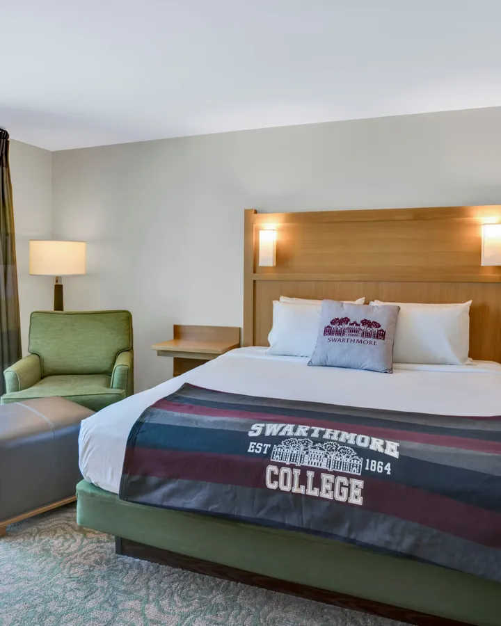 Inn at Swarthmore guest room with a Swarthmore College blanket on the bed