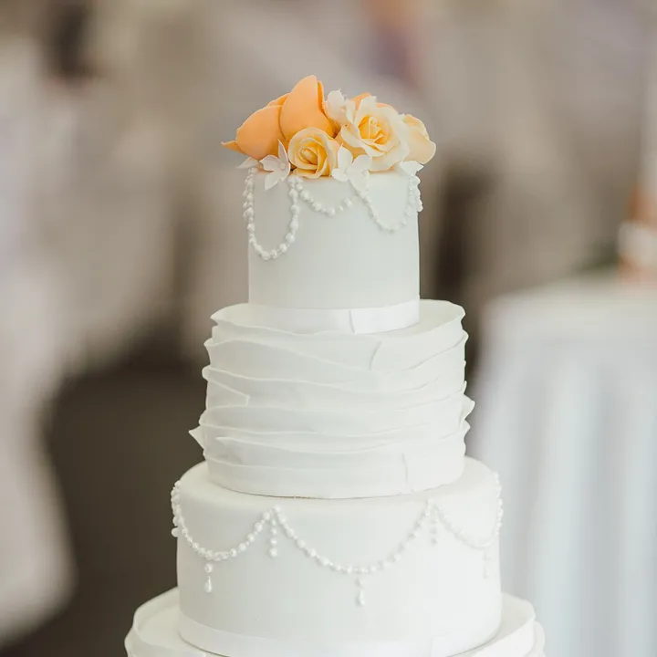 Tiered Wedding Cake With An Orange Flower