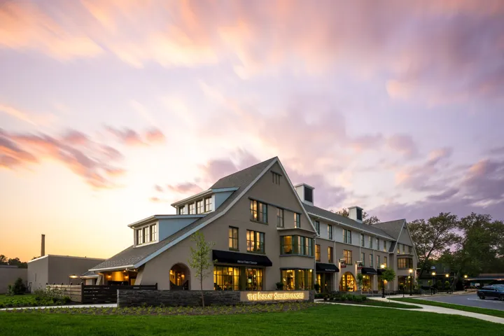 Exterior view of The Inn at Swarthmore during sunset with clouds